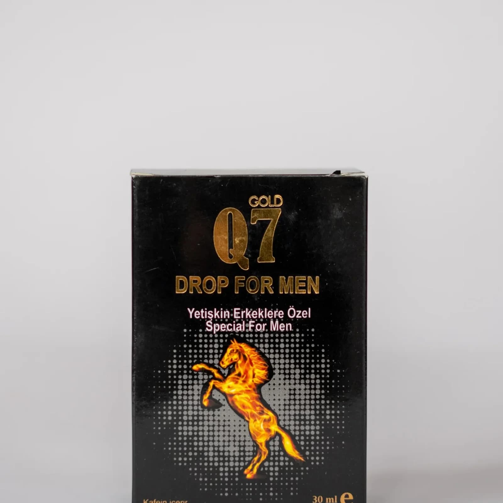 Q7 Gold drops for men, natural strength. Close-up of bottle and dropper.